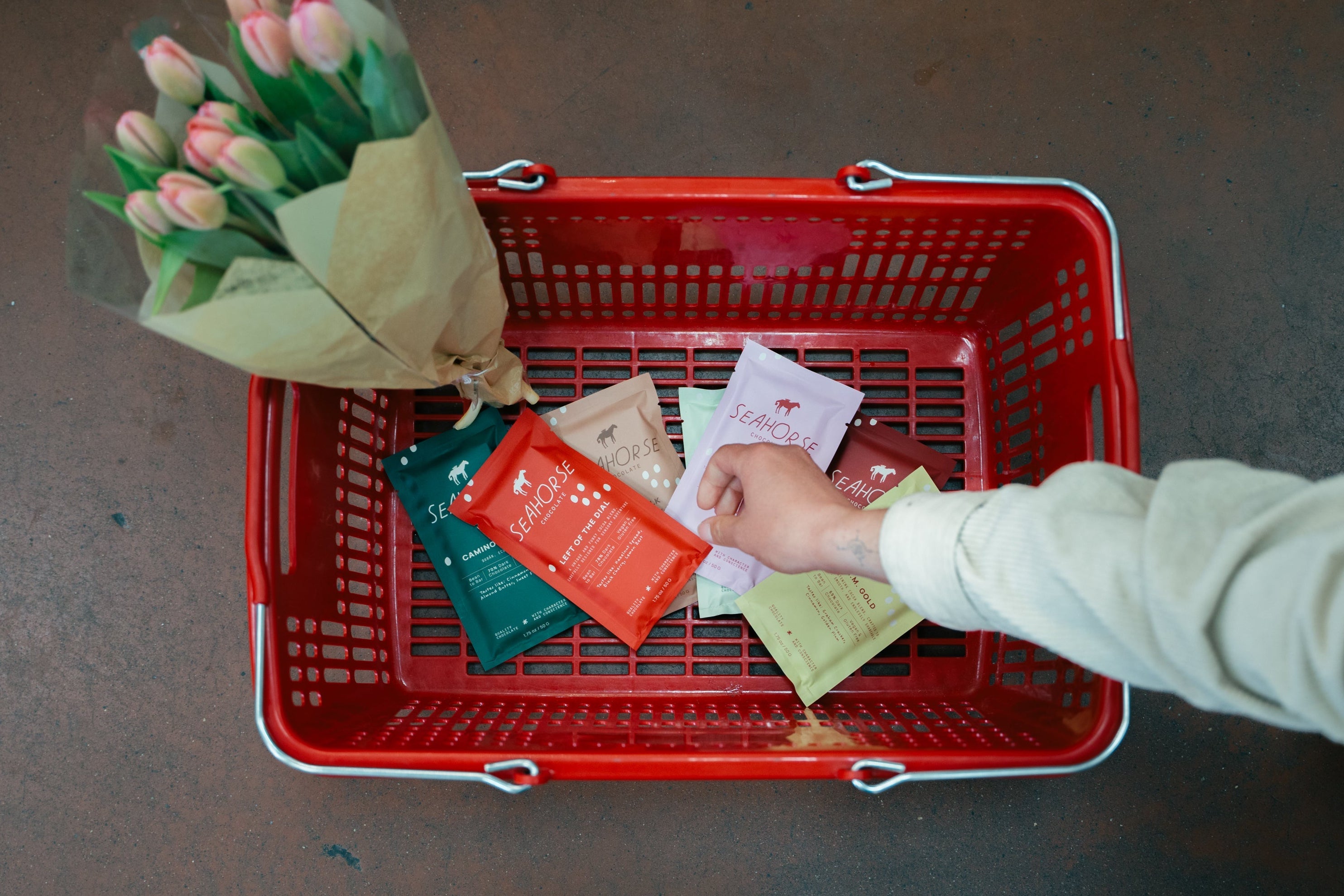 individual placing Seahorse Chocolate bars in shopping basket 