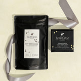 Seahorse Hot Cocoa Mix and a chocolate sampler box on beige background