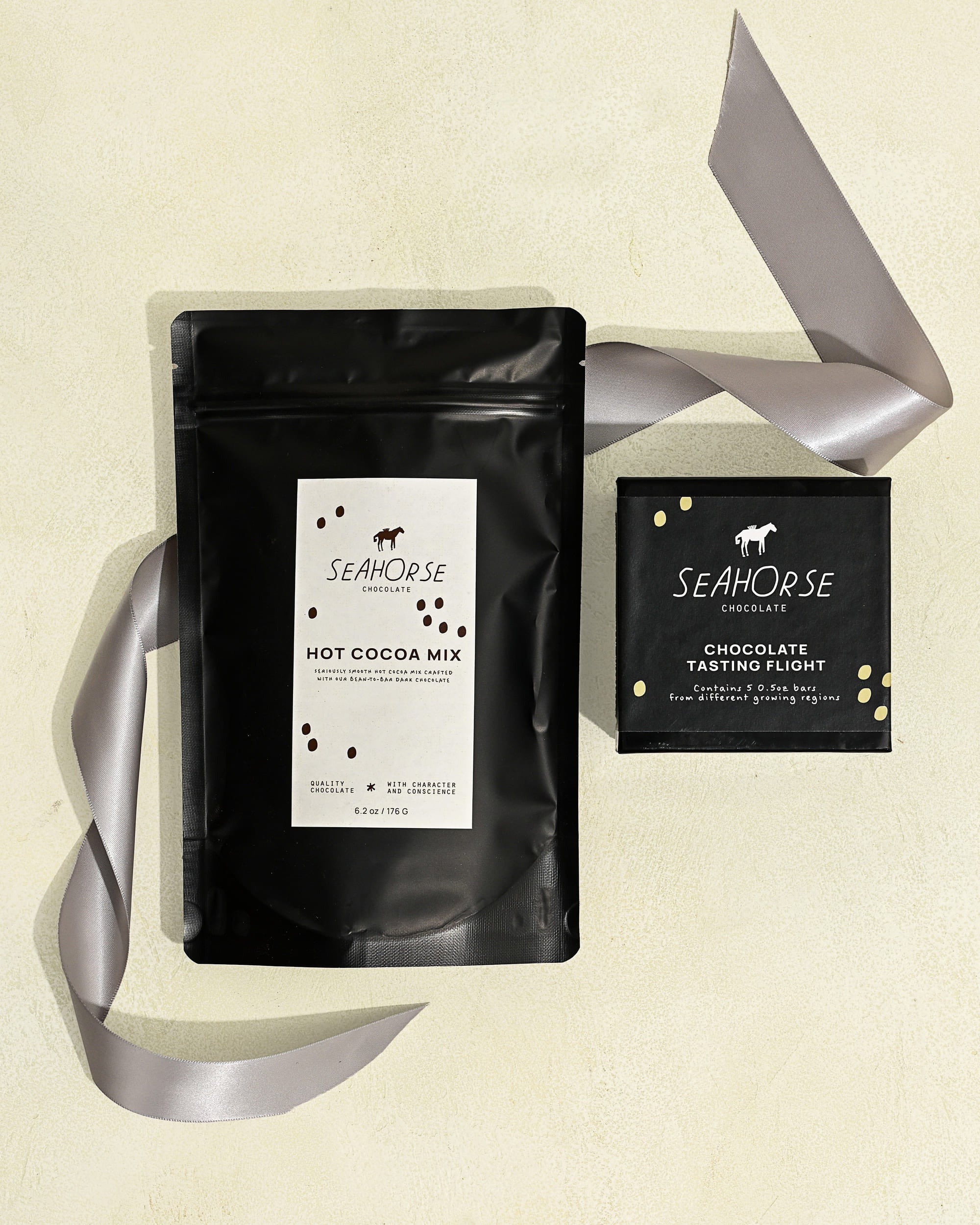 Seahorse Hot Cocoa Mix and a chocolate sampler box on beige background