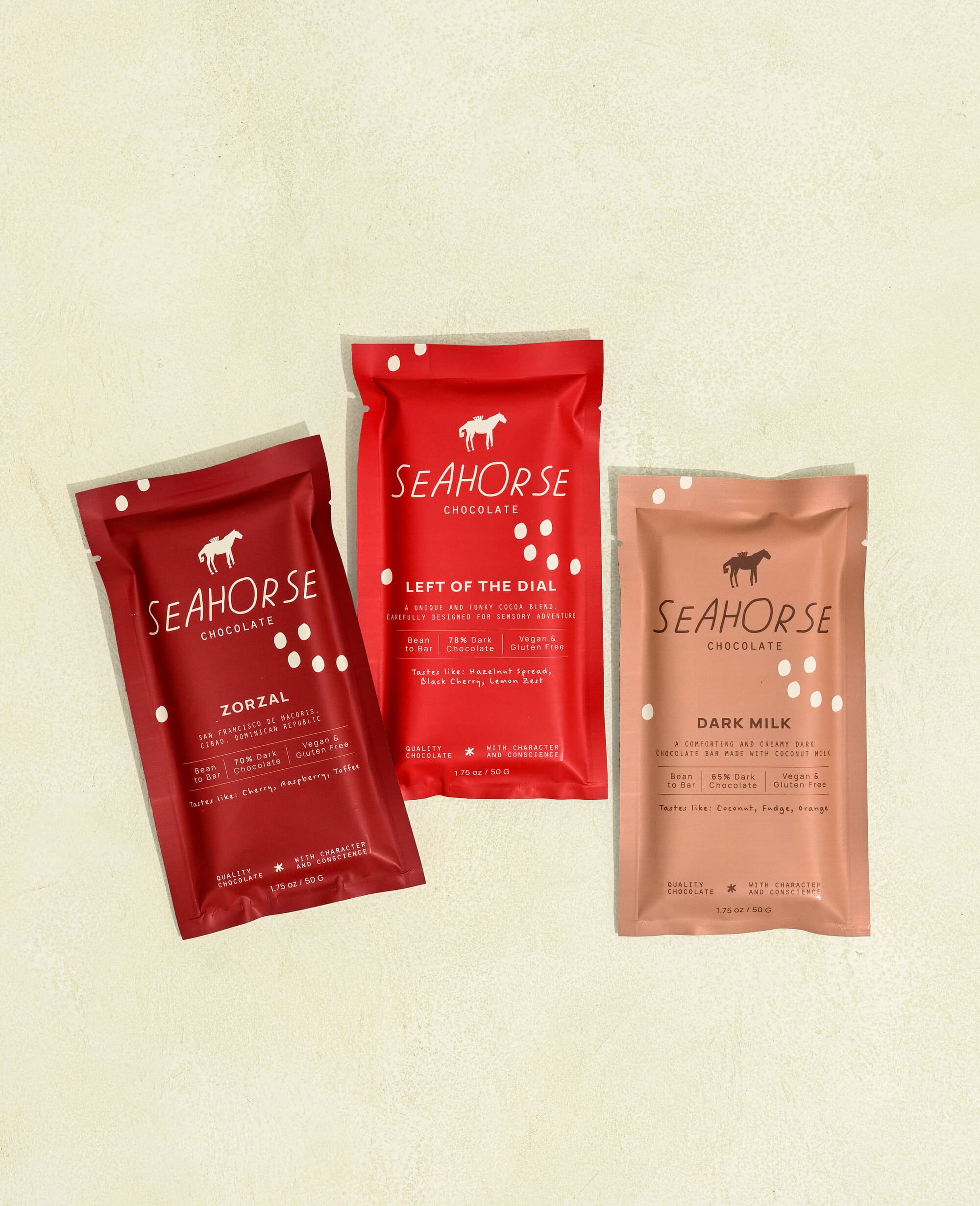 Three Seahorse Chocolate bars on a beige background