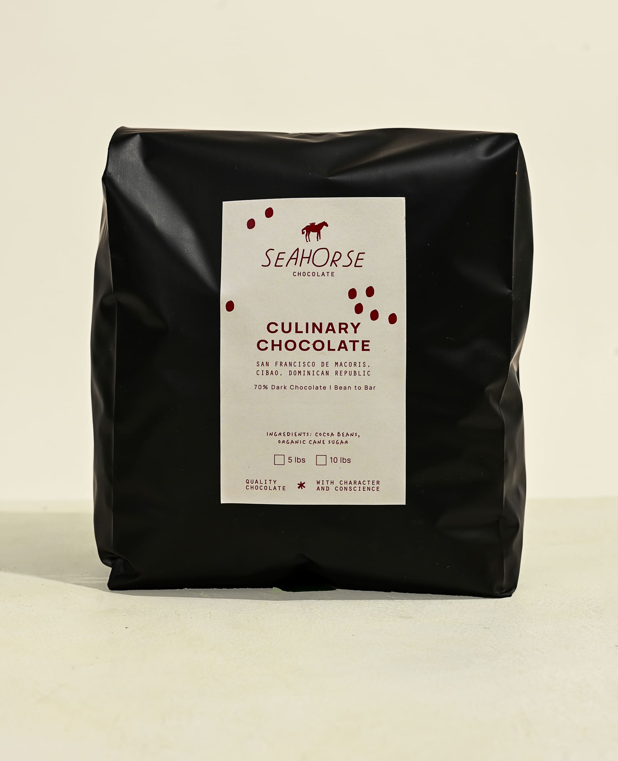 Black bag of Seahorse Culinary Chocolate on a beige background