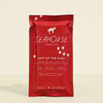 Red packaging of Seahorse Chocolate bar on a beige background