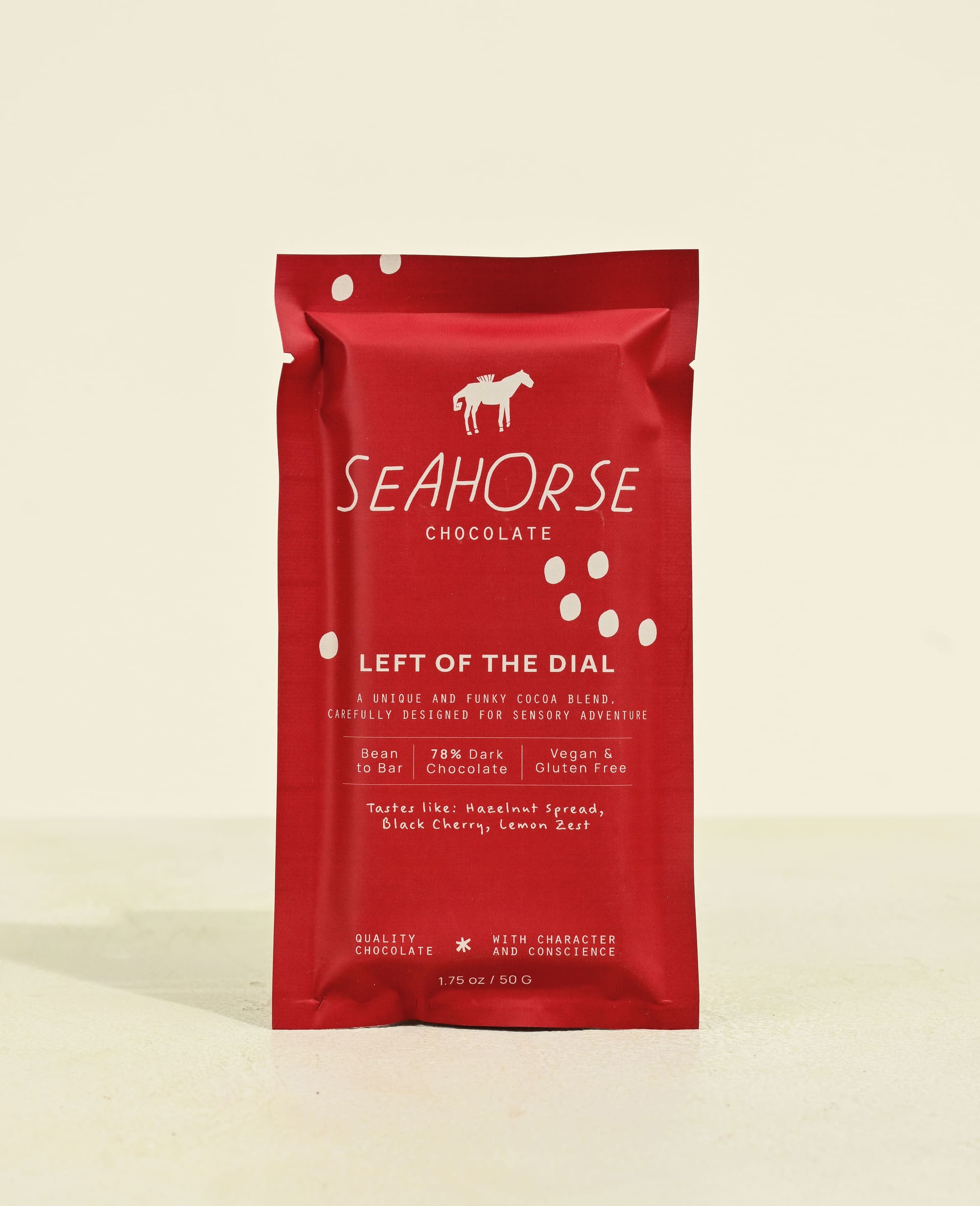 Red packaging of Seahorse Chocolate bar on a beige background