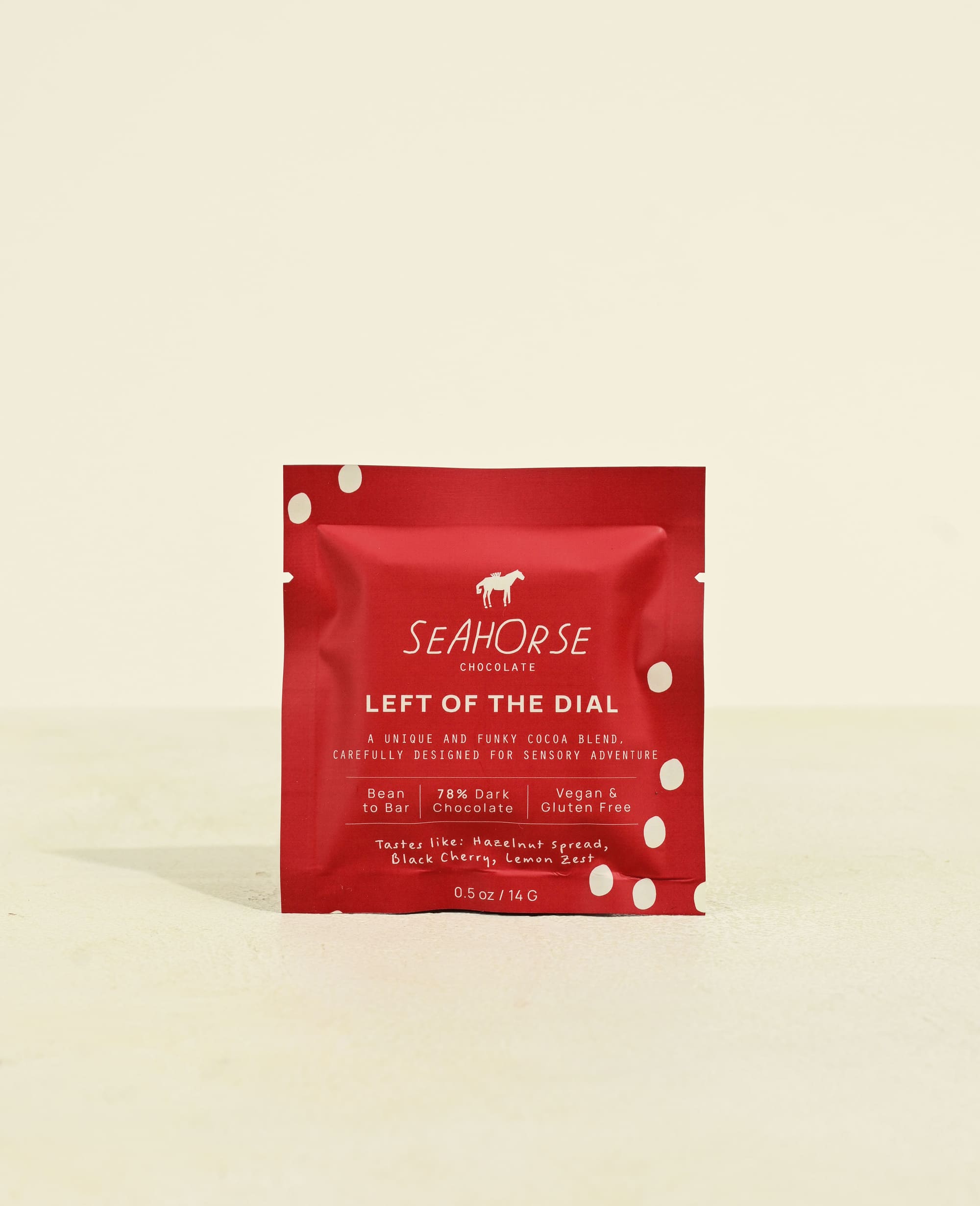 Red packaging of Seahorse Chocolate bar on a beige background
