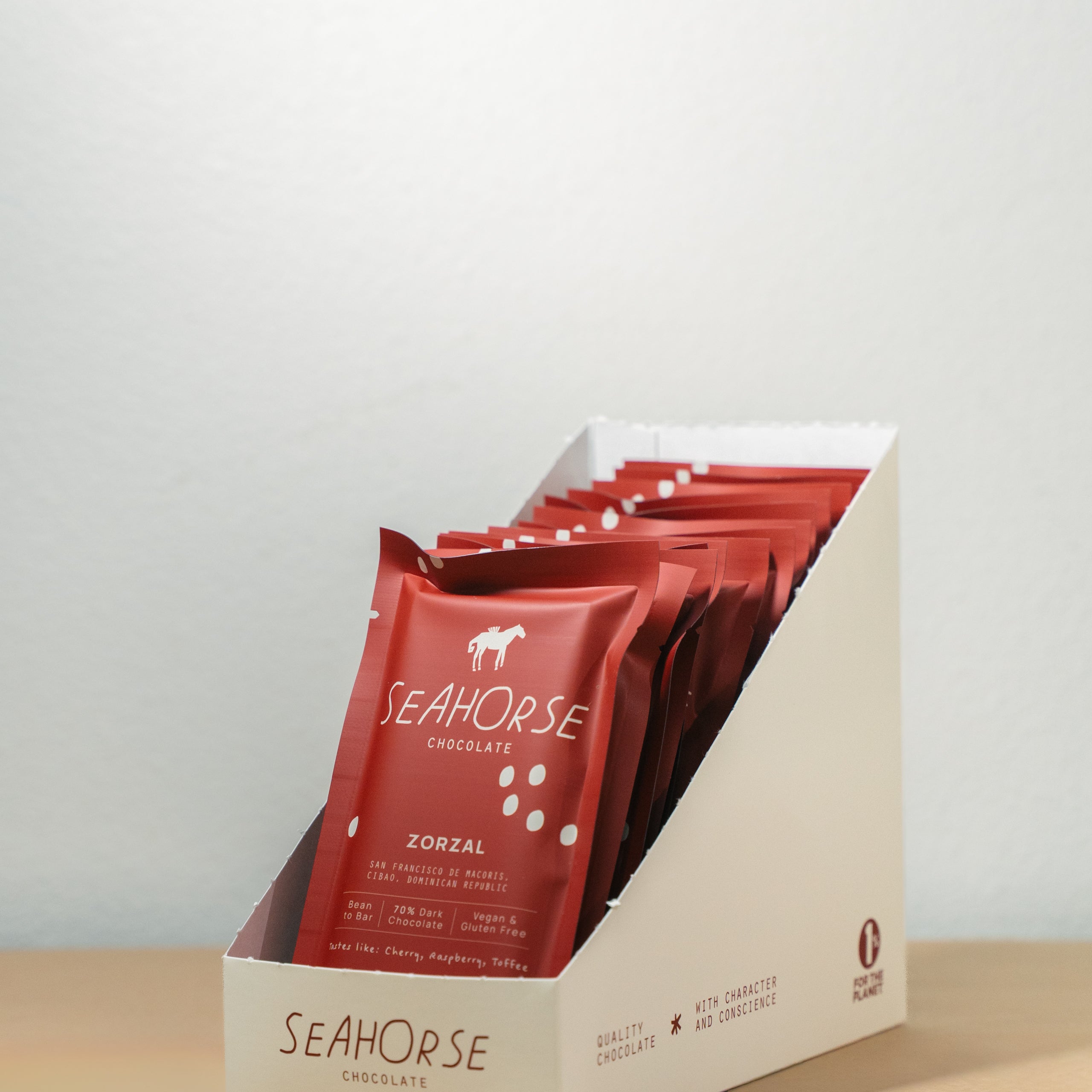 Red Seahorse chocolate bars in a display box on a beige surface with a light gray background