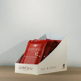 Red Seahorse chocolate bars in a white display box on a neutral background