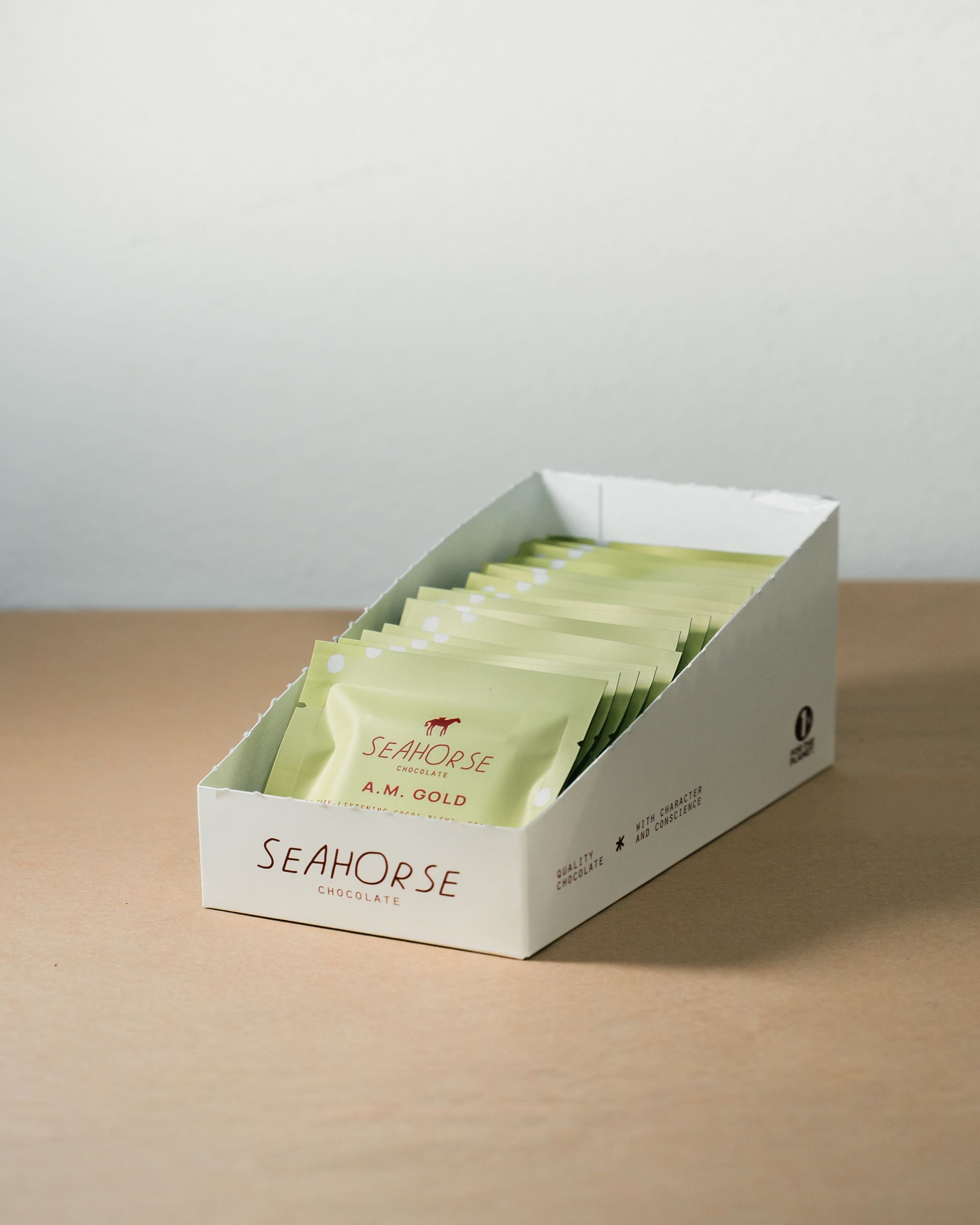 Box of Seahorse tea bags on a wooden surface with a light gray background