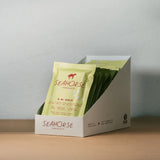 Box of Seahorse chocolate with a single package on a neutral background