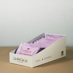 Box of Seahorse chocolate bars on a wooden surface with a light gray background