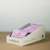 Box of Seahorse chocolate bars on a wooden surface with a light gray background